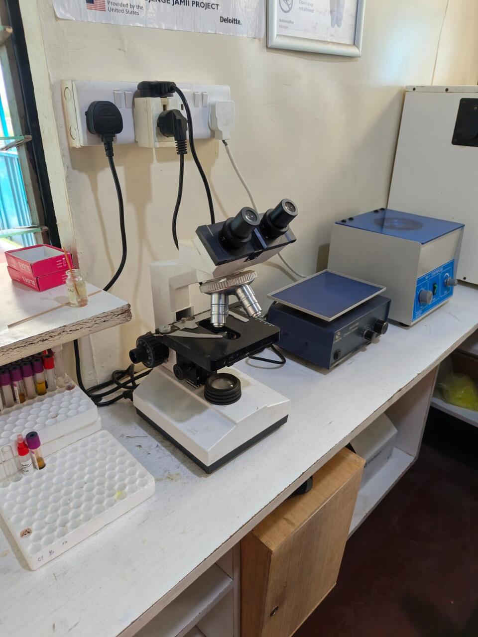 A microscope and sample racks in the Primegala laboratory